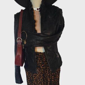 Leather jacket with cheetah print lining on the inside. Lots of frilly detail.